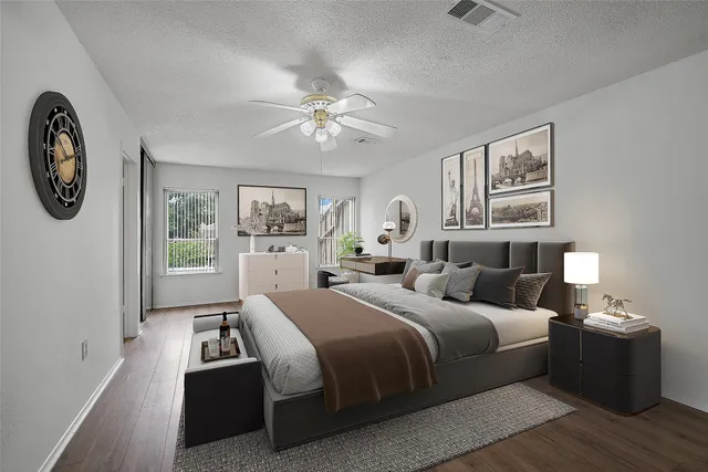 a spacious bedroom with a bed and a chandelier