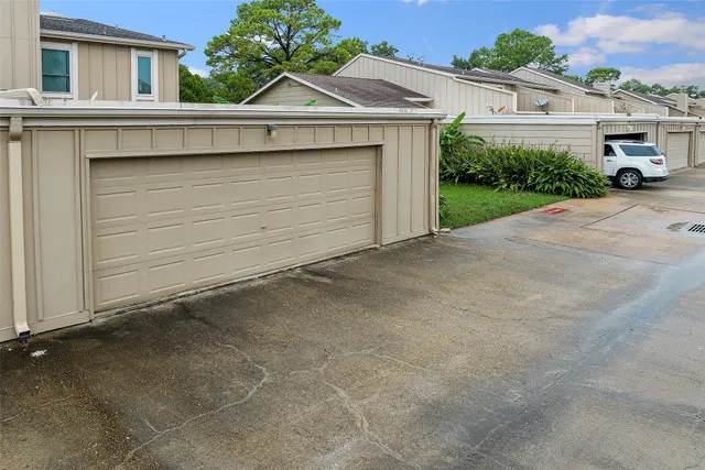 an aerial view of a house with garden space and street view