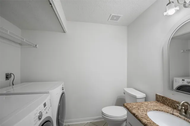 a bathroom with a sink a toilet and a mirror