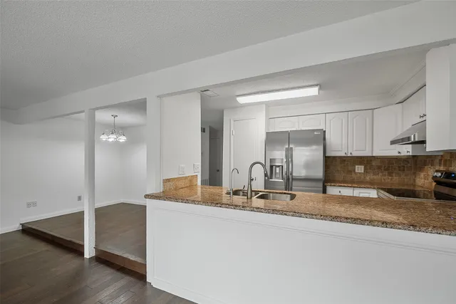 a bathroom with a granite countertop sink and mirror