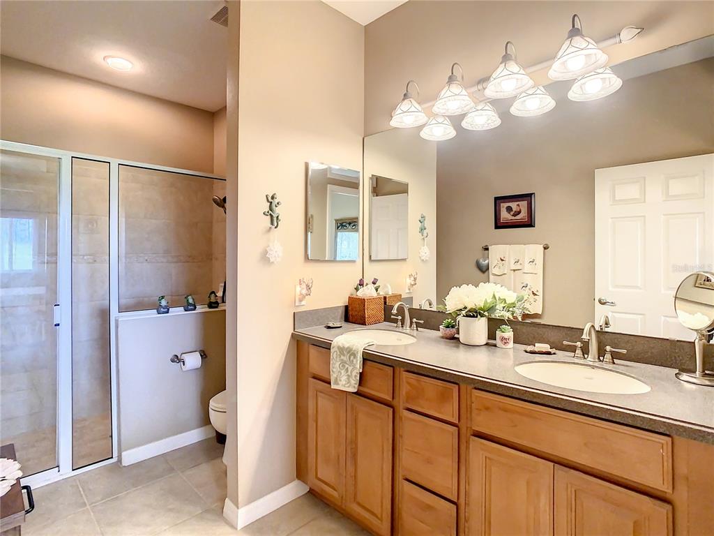 2646 Rutledge Court Winter Haven, FL 33884 - Photo 14 of 23 a spacious bathroom with a double vanity sink mirror and shower