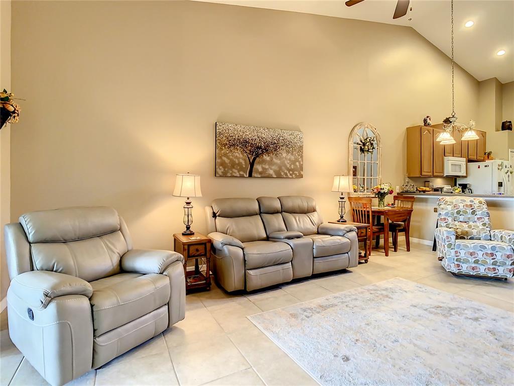 2646 Rutledge Court Winter Haven, FL 33884 - Photo 6 of 23 a living room with furniture and a chandelier
