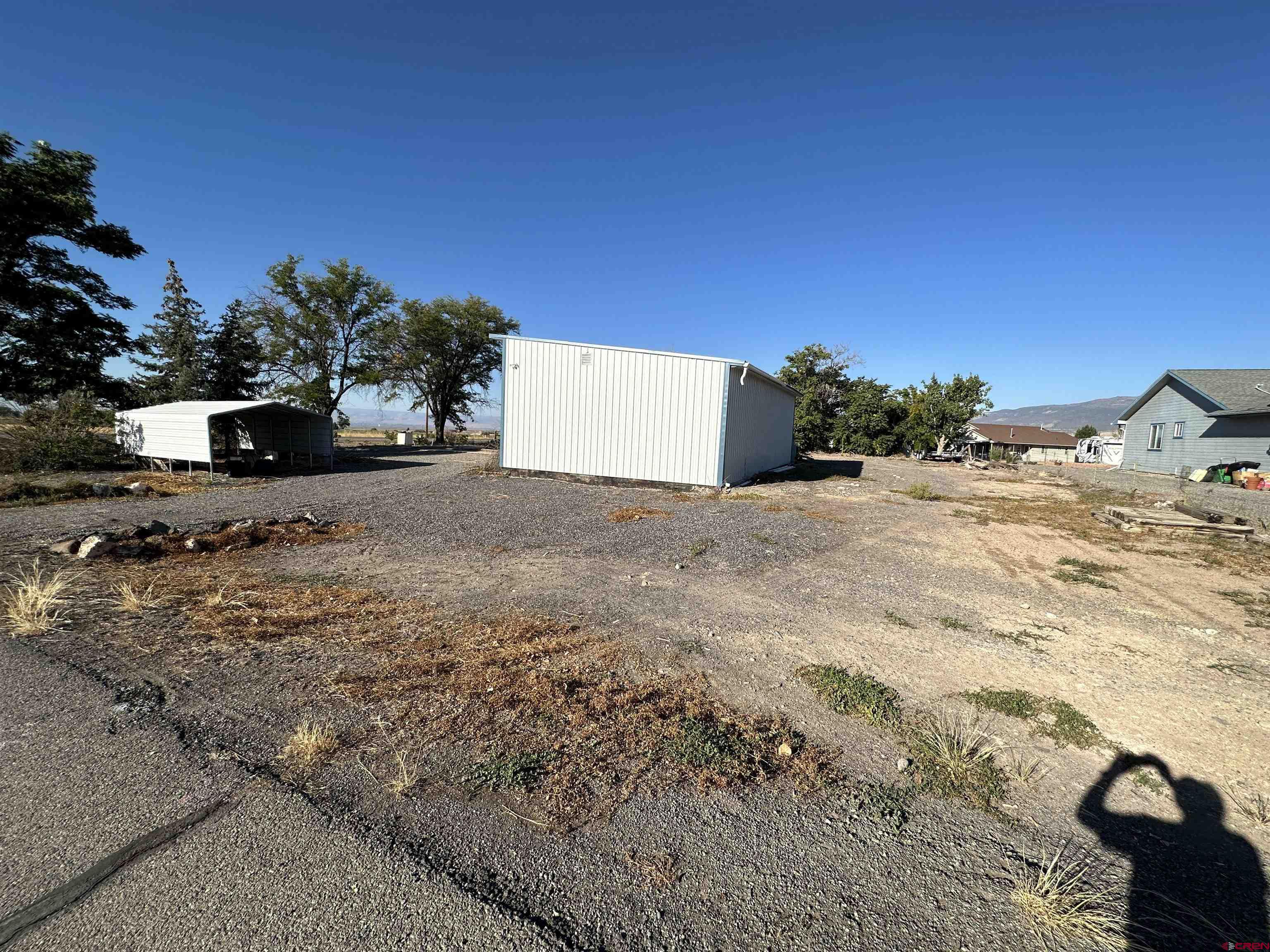20696 Del Ray Drive Eckert, CO 81418 - Photo 8 of 8 a view of a dry yard with a house in the background