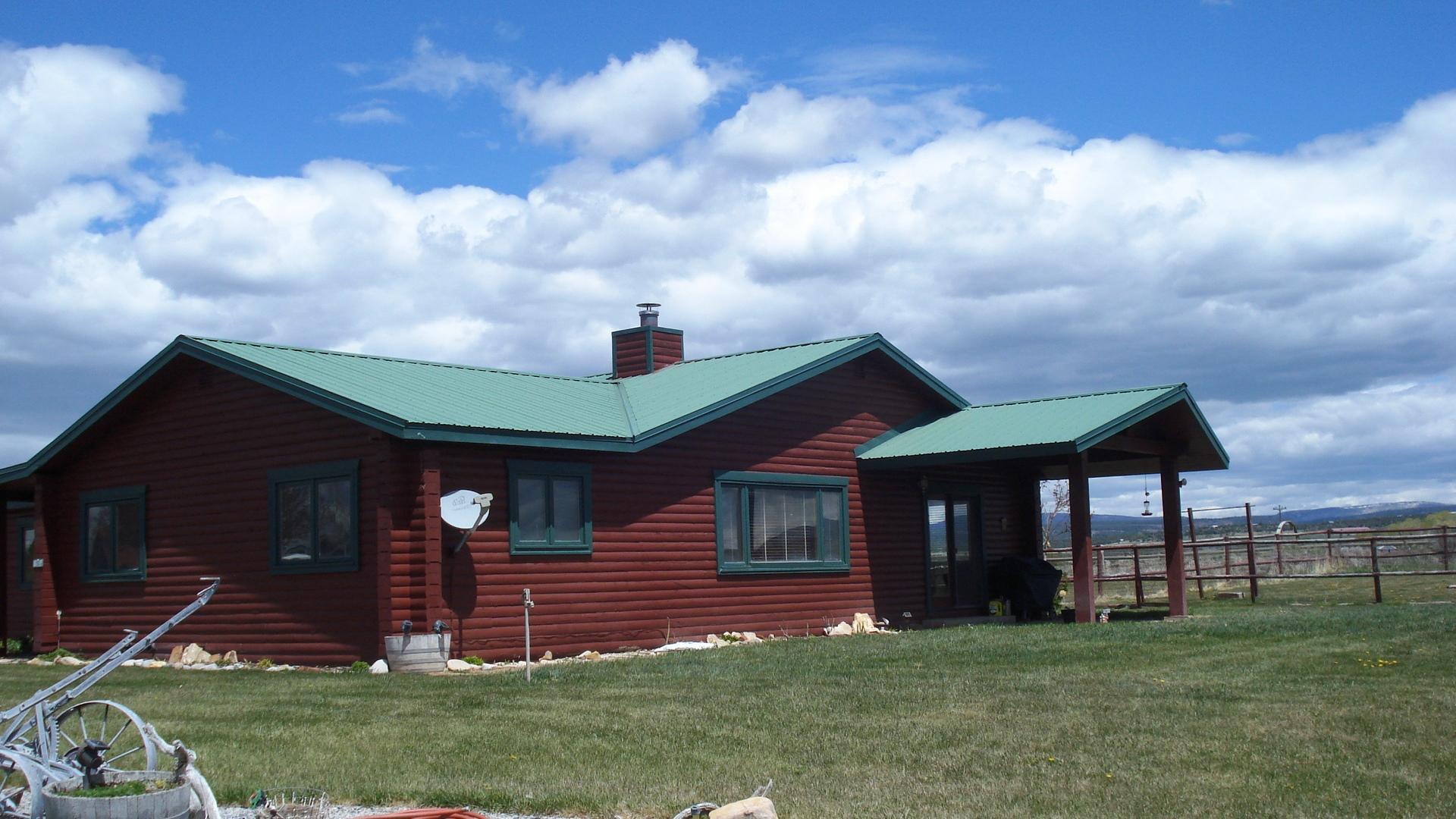 50 Homestead Road Norwood, CO 81423 - Photo 20 of 25 a front view of a house with garden