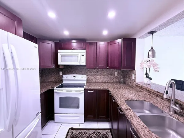 a kitchen with a sink stove and refrigerator