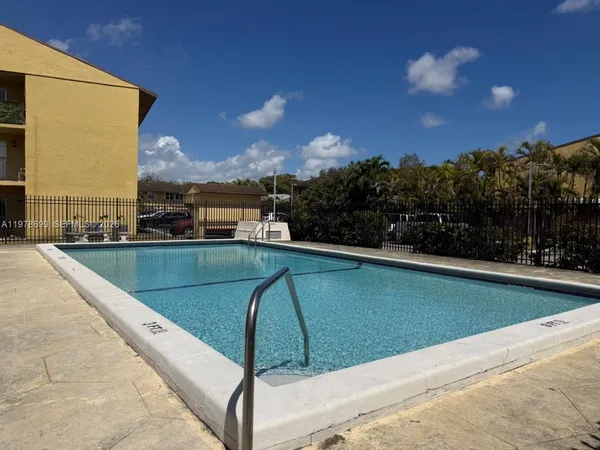 a view of a swimming pool and a yard