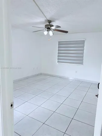 a view of a livingroom with a fan and a ceiling fan