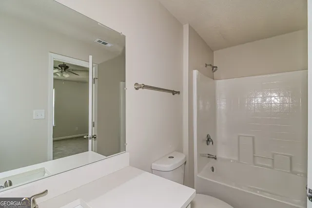 a bathroom with a sink toilet tub and shower