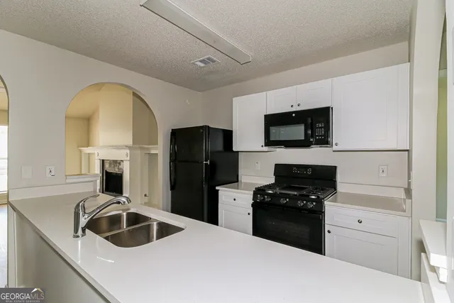 a kitchen with a sink cabinets and stainless steel appliances