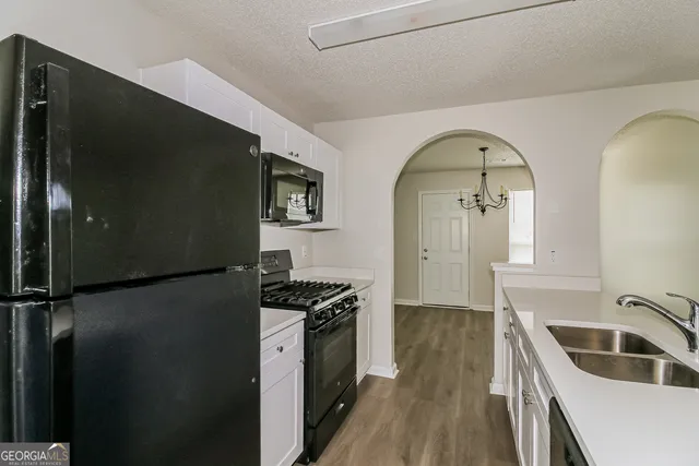 a kitchen with a refrigerator and a sink