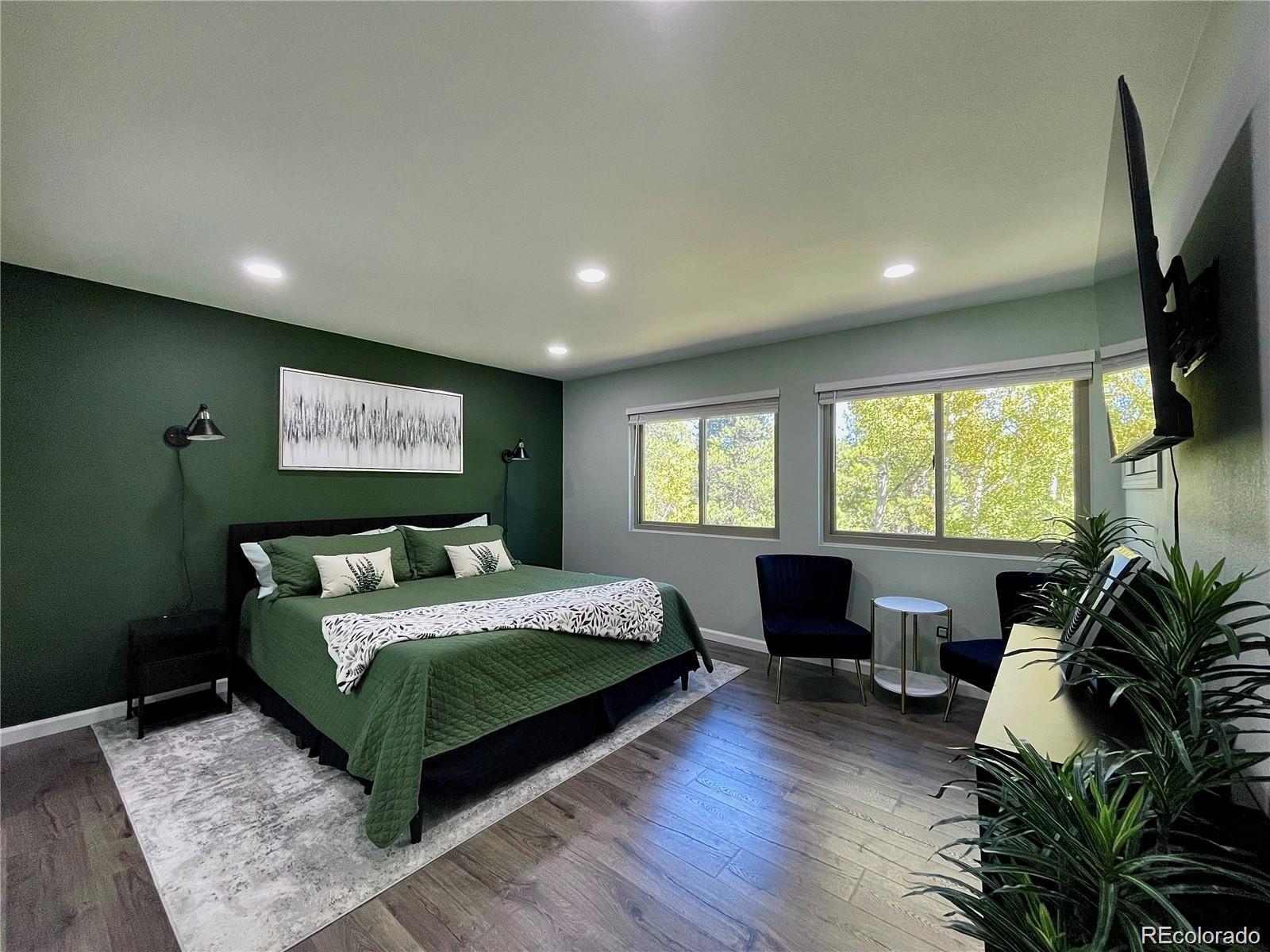 265 Caesar Road Black Hawk, CO 80422 - Photo 24 of 42 a bedroom with a large bed and a potted plant