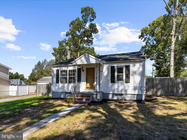 a front view of house with yard space and balcony