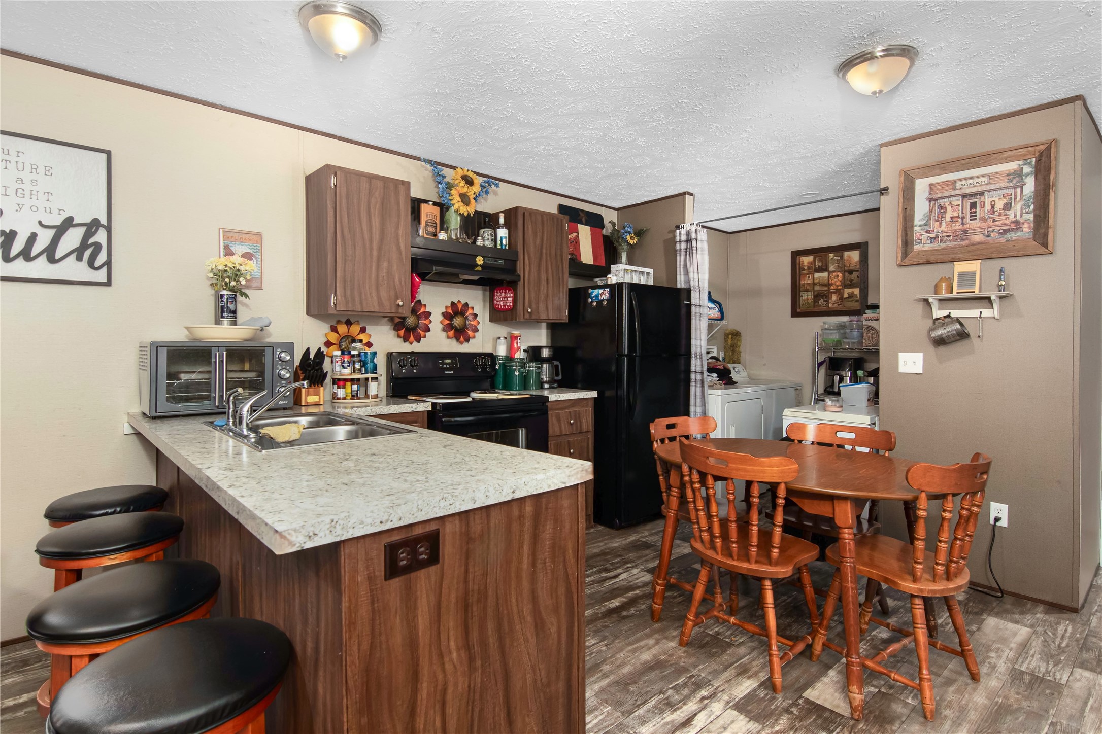 18093 Pickering Road Conroe, TX 77302 - Photo 9 of 29 a kitchen with a table and chairs in it