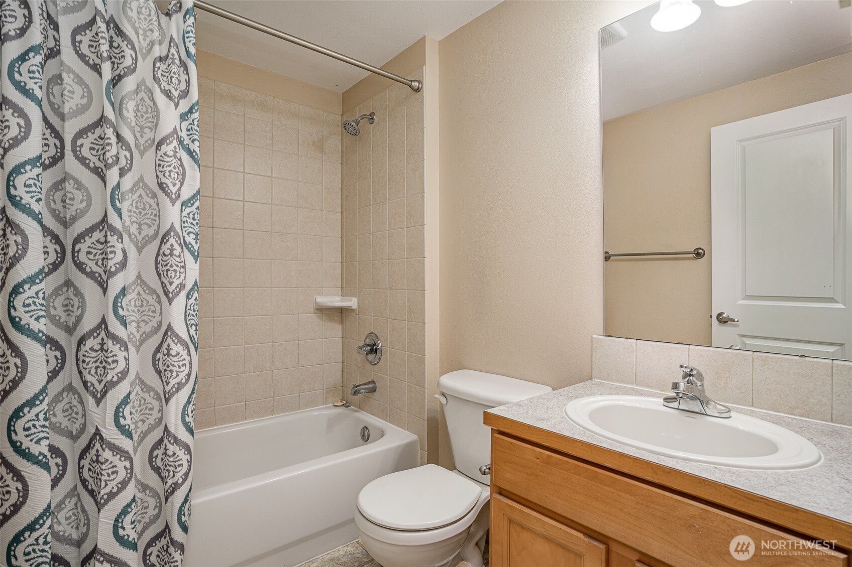 10710 Whitman Avenue North, Unit B Seattle, WA 98133 - Photo 12 of 18 a bathroom with a sink toilet tub vanity and shower
