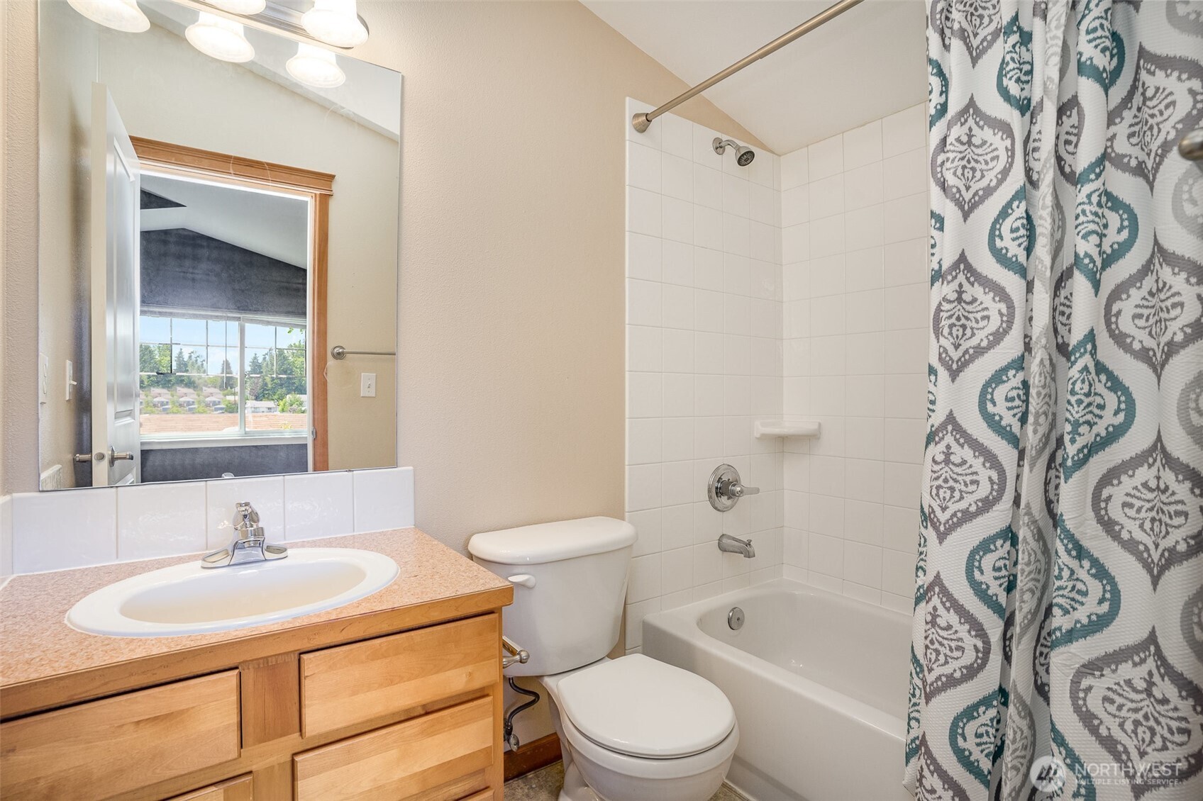 10710 Whitman Avenue North, Unit B Seattle, WA 98133 - Photo 15 of 18 a bathroom with a sink toilet and shower