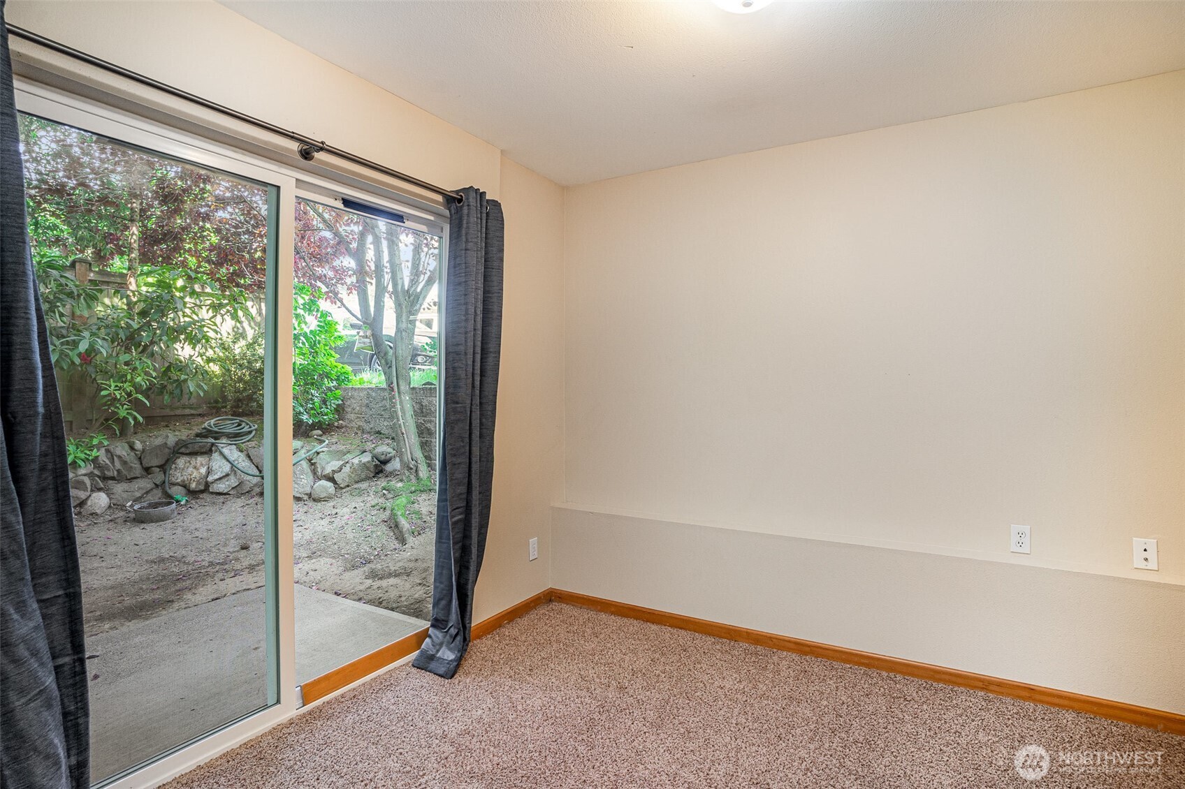 10710 Whitman Avenue North, Unit B Seattle, WA 98133 - Photo 17 of 18 a view of a room with sliding glass door