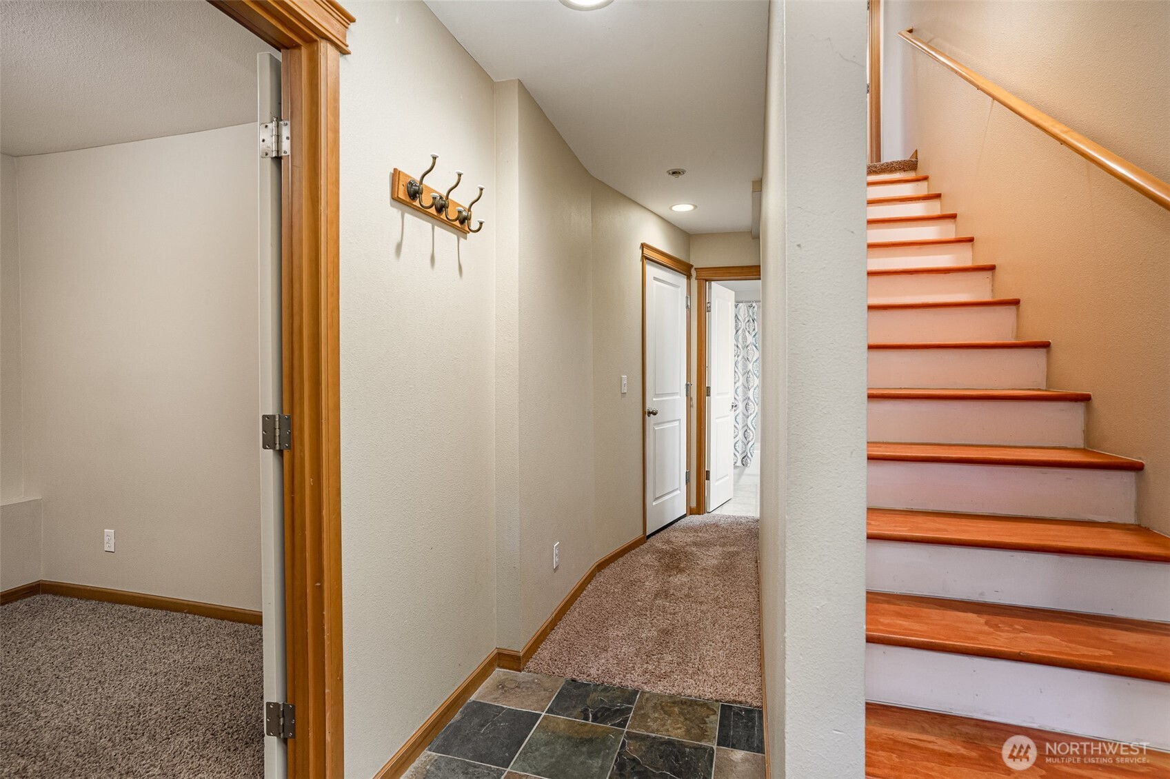 10710 Whitman Avenue North, Unit B Seattle, WA 98133 - Photo 2 of 18 a view of a hallway with wooden floor and staircase