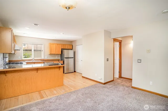 a large kitchen with stainless steel appliances granite countertop a refrigerator and a sink