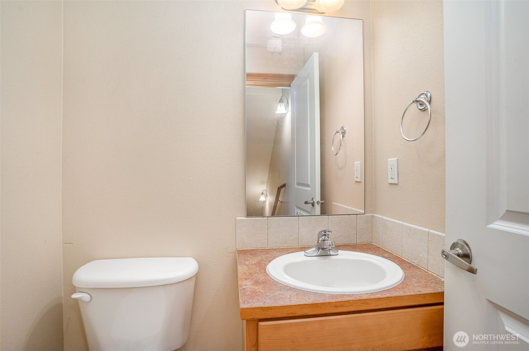 10710 Whitman Avenue North, Unit B Seattle, WA 98133 - Photo 8 of 18 a bathroom with a sink and a mirror