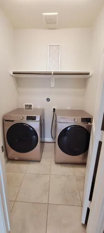a view of a sink with washer and dryer
