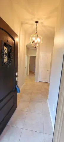 a view of a hallway with a chandelier