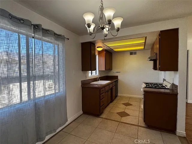 a kitchen with a refrigerator and a stove top oven