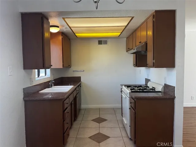 a kitchen with a sink stove and cabinets