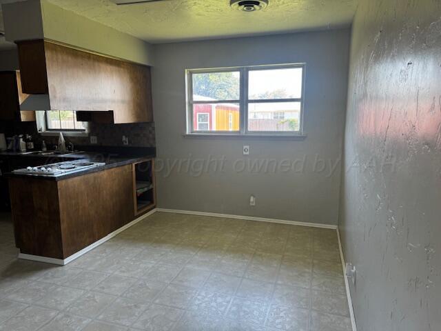 2121 Colgate Drive Perryton, TX 79070 - Photo 15 of 18 a kitchen with a stove a sink and a window