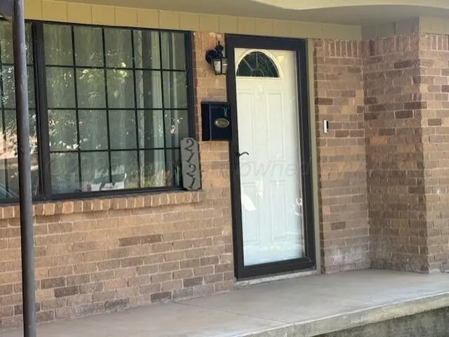 a view of a door and wooden floor