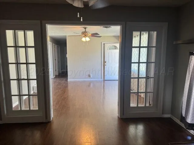 an empty room with wooden floor and a window