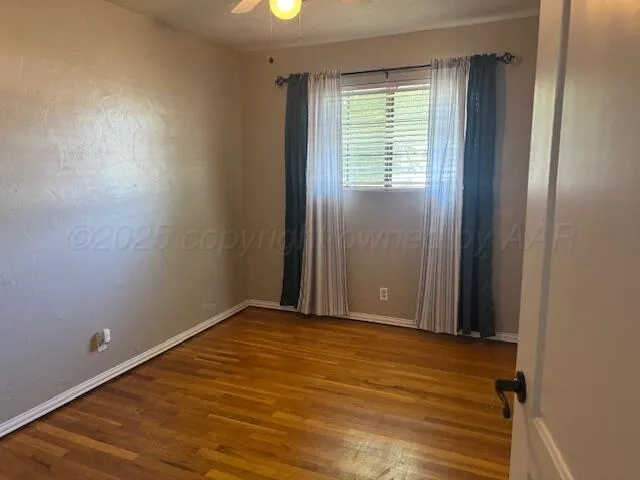 an empty room with a window and a fireplace