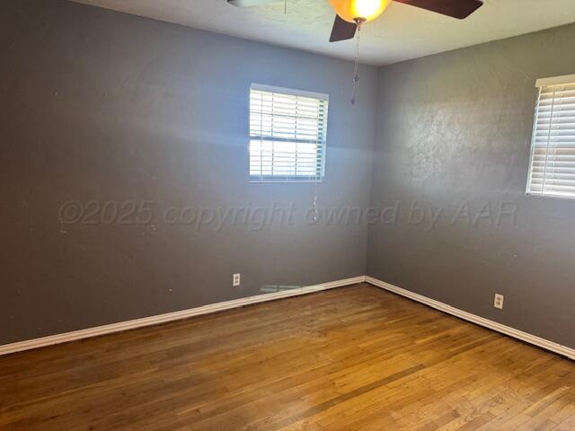 2121 Colgate Drive Perryton, TX 79070 - Photo 9 of 18 an empty room with a window and a fireplace