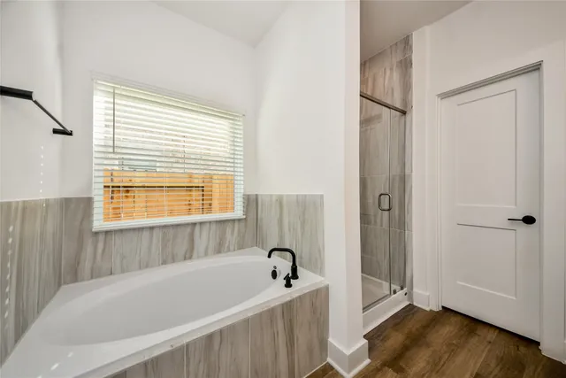 a bathroom with a bathtub and a window