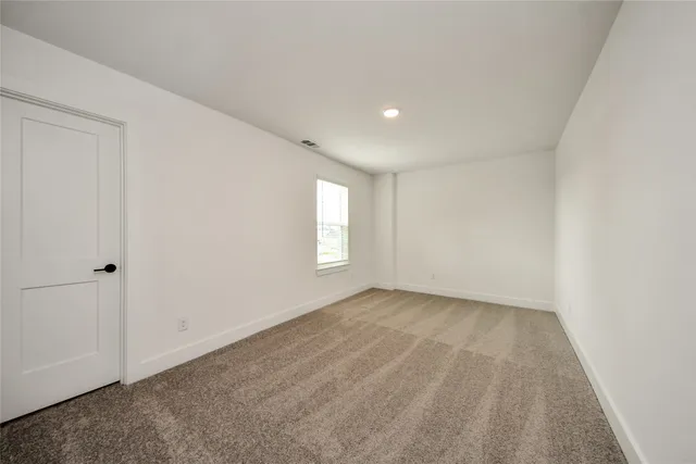 a view of an empty room and a window