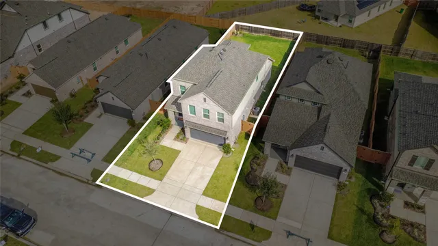 an aerial view of a house with a swimming pool