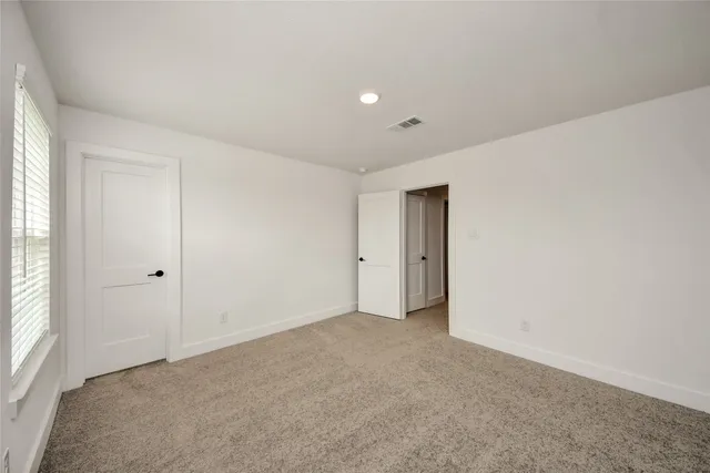 a view of an empty room and a window