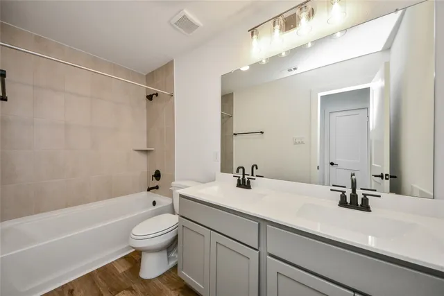 a bathroom with a sink a toilet and a bathtub