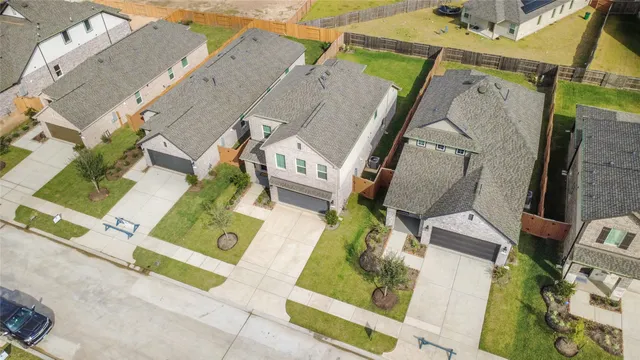 an aerial view of residential houses with outdoor space