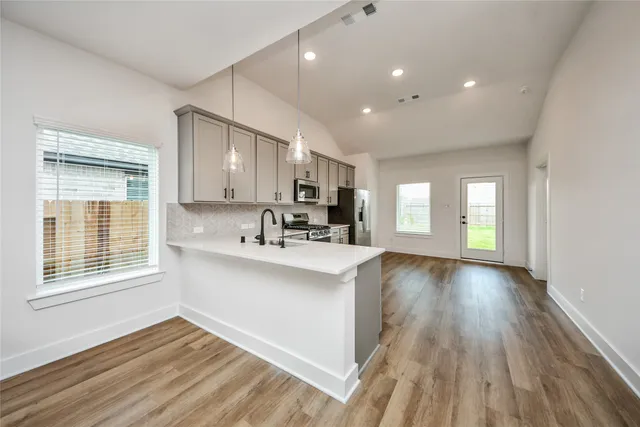 a view of kitchen with sink and wooden floor