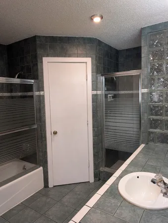a bathroom with a bathtub and a sink