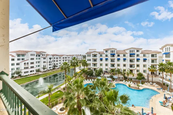 a view of a swimming pool with outdoor seating