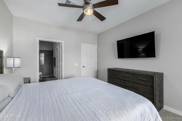 a bedroom with a bed and a flat screen tv