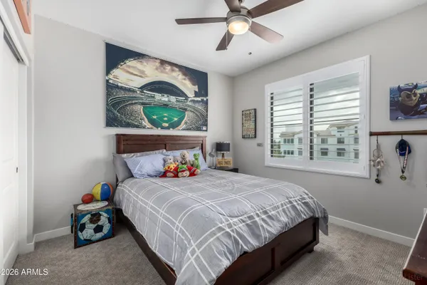 a bedroom with a bed and a chandelier