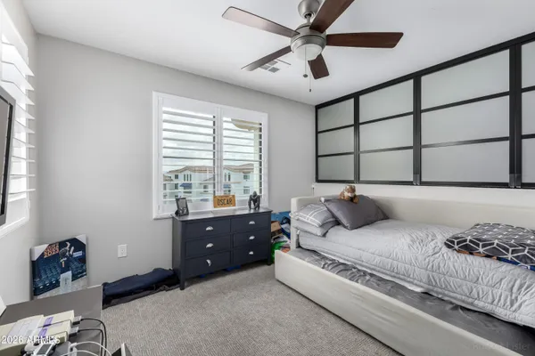 a bedroom with a bed and a window