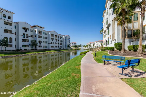 a view of a lake with a building and a big yard