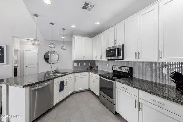 a kitchen with a sink stove and microwave