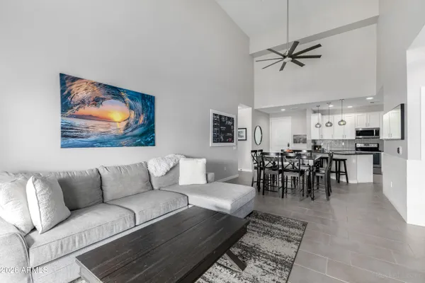 a living room with furniture and kitchen view