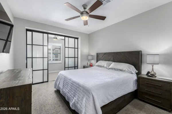 a bedroom with a bed and a lamp