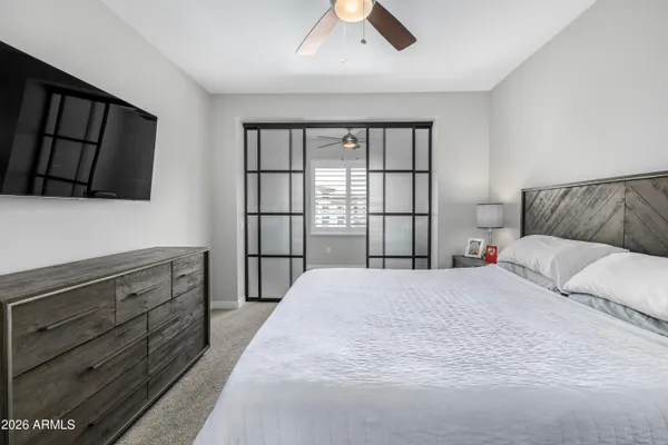 a bedroom with a large bed and a tv