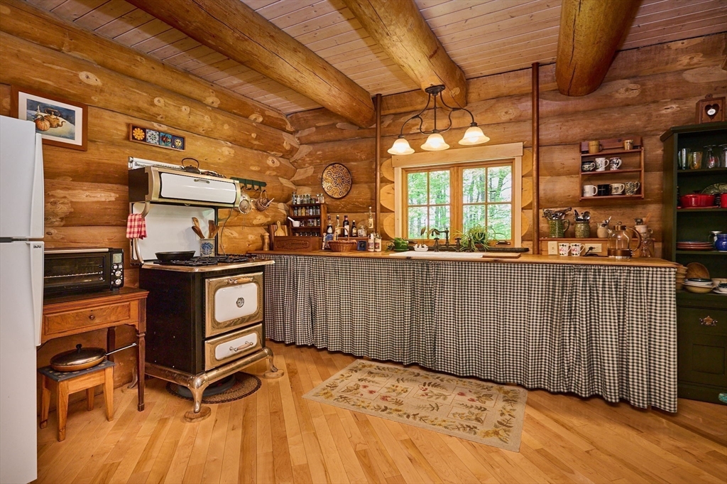 486 Old Stage Road Ashfield, MA 01330 - Photo 10 of 36 a room with stainless steel appliances kitchen island granite countertop a refrigerator a stove and a wooden floors
